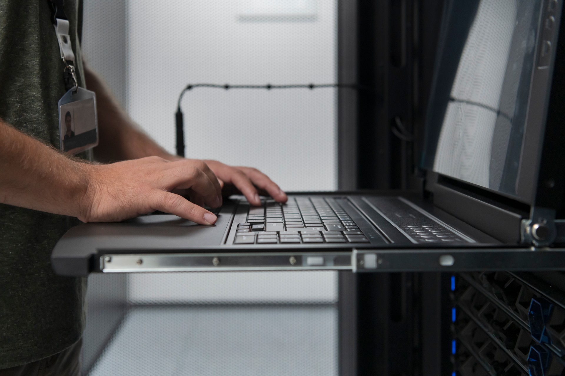 Close up on Data Center Engineer hands Using keyboard on a supercomputer Server Room Specialist Facility with Male System Administrator Working with Data Protection Network for Cyber Security.